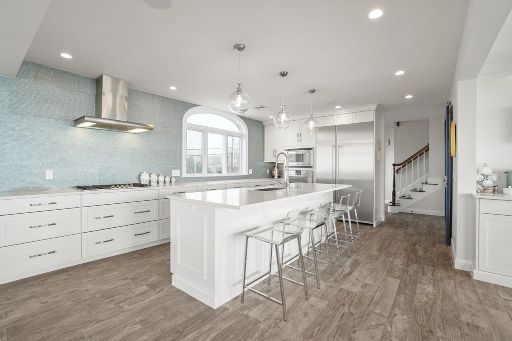 123 Gurnet Road Duxbury, MA 02332 - Photo 9 of 42 a large kitchen with stainless steel appliances a large counter top a sink a stove and a refrigerator