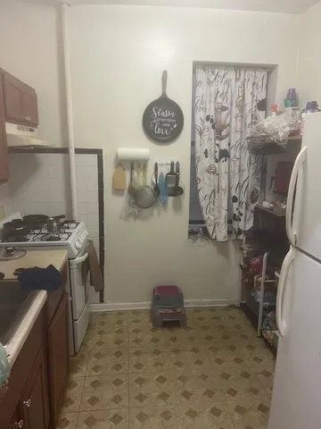 a kitchen with a refrigerator and a stove