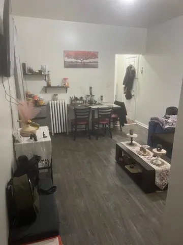 a bedroom with furniture and a wooden floor