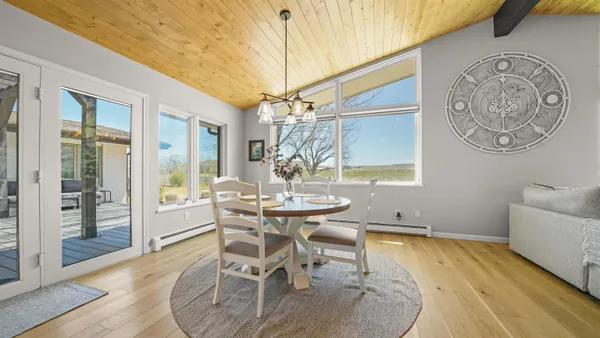 a view of a dining room with furniture and wooden floor