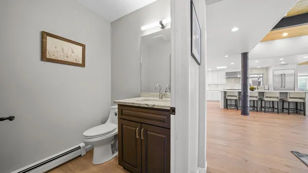 a bathroom with a toilet a sink and mirror