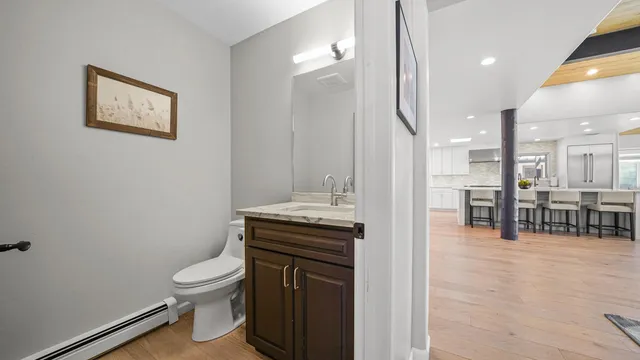 a bathroom with a toilet a sink and mirror