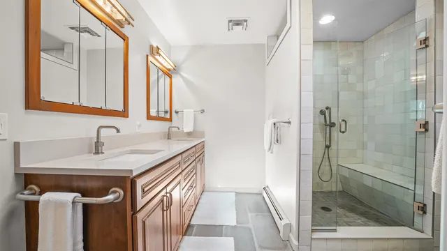 a bathroom with a sink a mirror and a shower