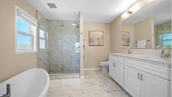 a bathroom with a sink a toilet and shower