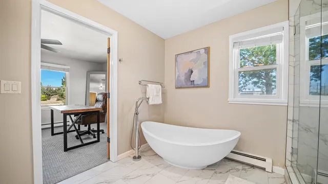 a bathroom with a toilet a sink and a window