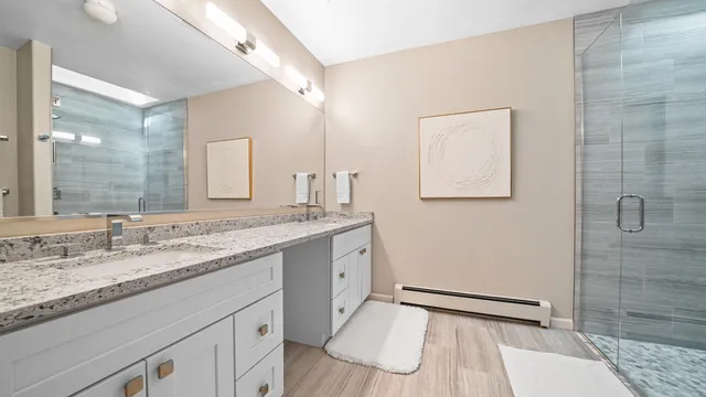 a bathroom with a granite countertop sink mirror and double