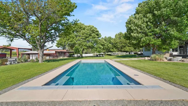 a view of swimming pool with a yard