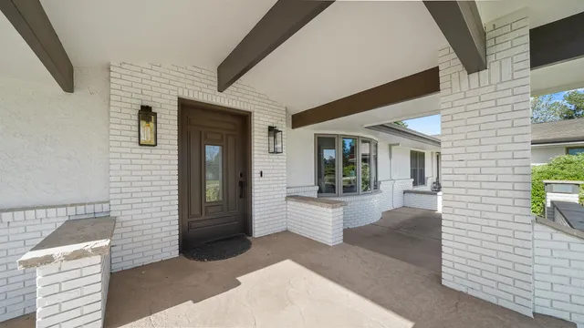 a view of a patio with table and chairs and potted plants