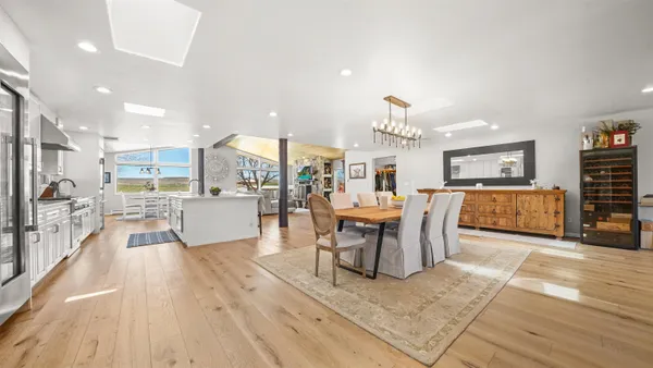 a living room with furniture a dining table and kitchen view
