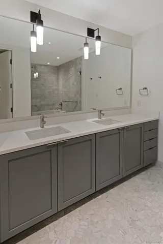 a bathroom with a sink vanity and mirror