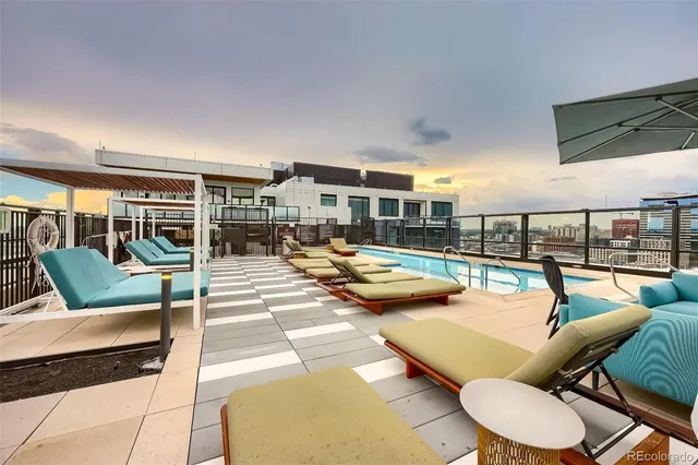 a view of a patio with swimming pool table and chairs
