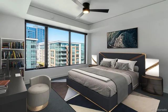 a bedroom with bed and a large window