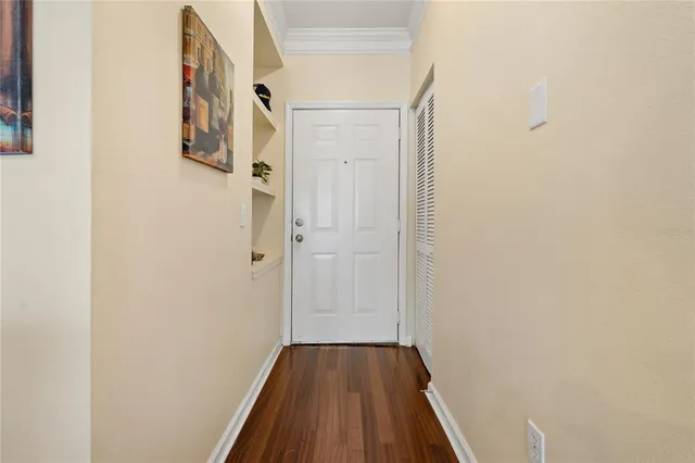 a view of a hallway with wooden floor and entryway