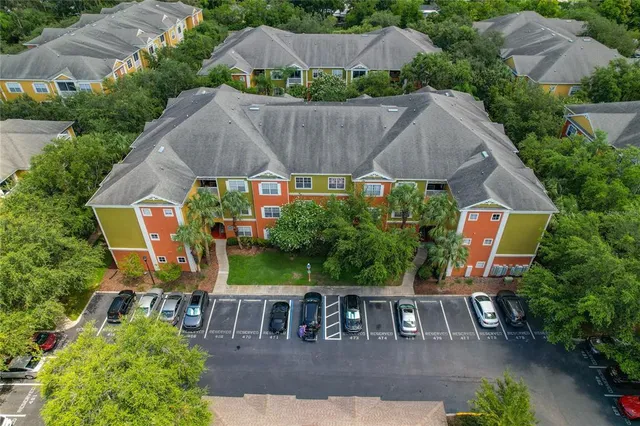 an aerial view of a house with swimming pool and outdoor seating