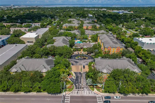 an aerial view of residential houses with outdoor space and street view