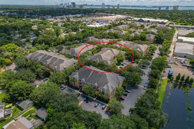 an aerial view of residential houses with outdoor space and river
