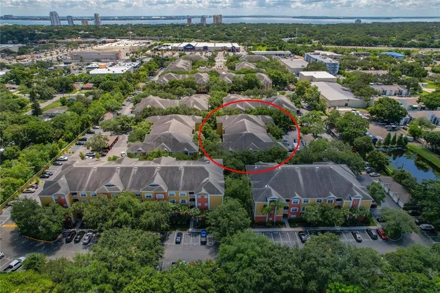 an aerial view of residential houses with outdoor space and parking space