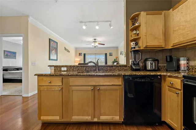 a kitchen with stainless steel appliances granite countertop a sink and cabinets