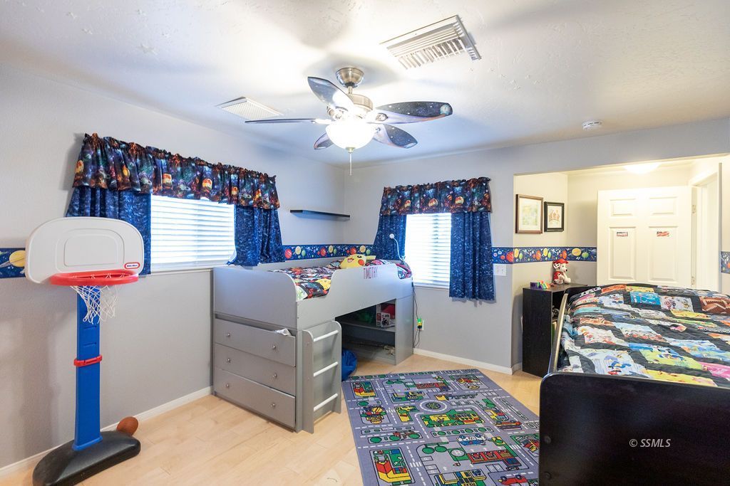 737 Scott Circle Ridgecrest, CA 93555 - Photo 30 of 49 a bedroom with furniture and a chandelier
