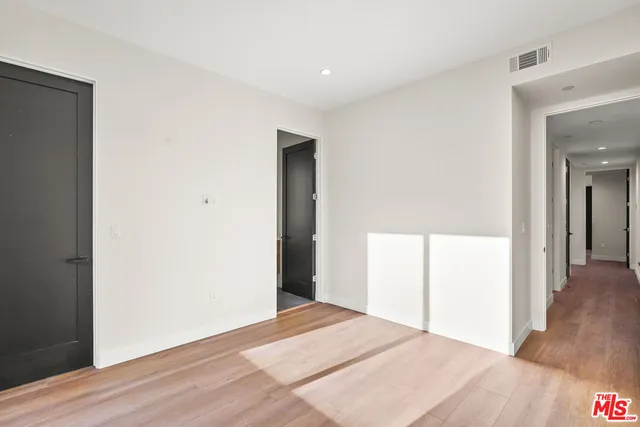 a view of hallway with wooden floor