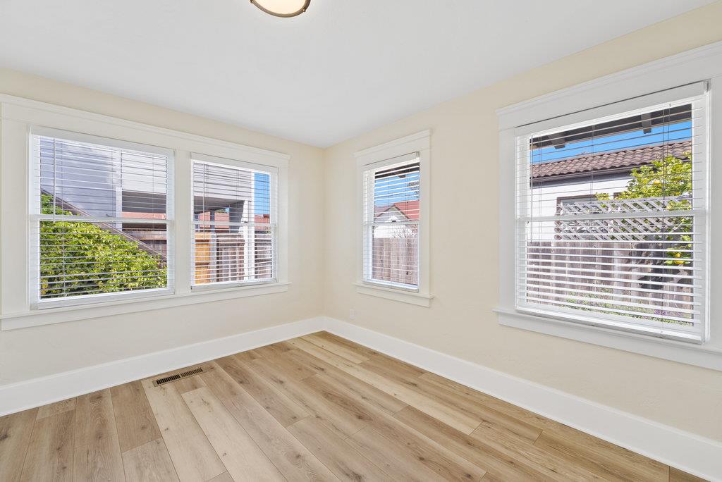 219-a Leonard Street Santa Cruz, CA 95060 - Photo 11 of 32 a view of an empty room with wooden floor and a window