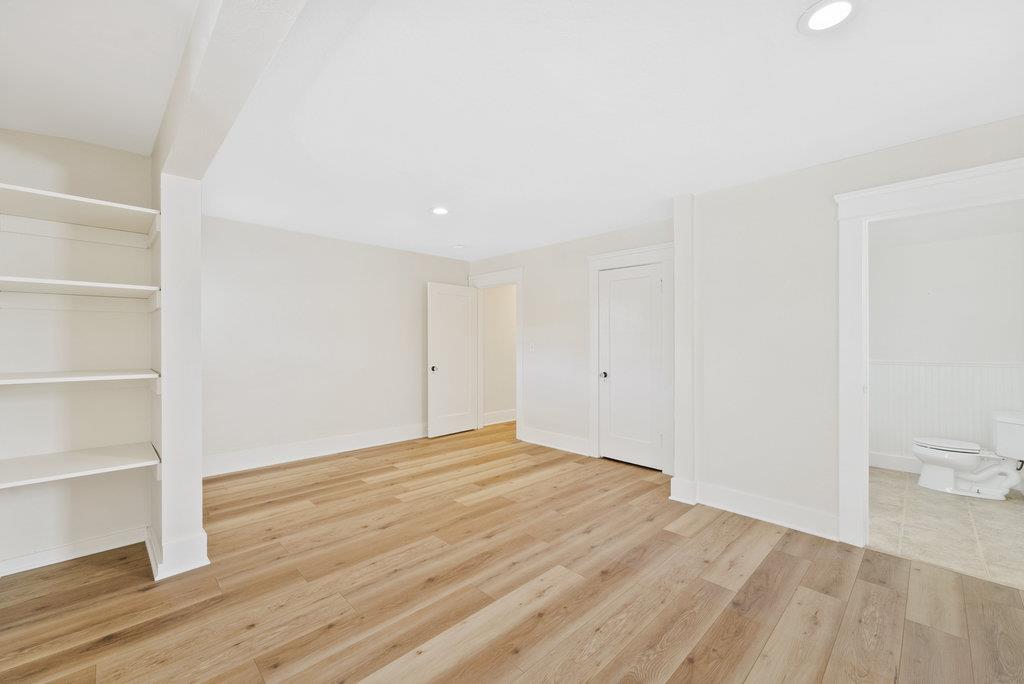 219-a Leonard Street Santa Cruz, CA 95060 - Photo 14 of 32 a view of an empty room with wooden floor and a window