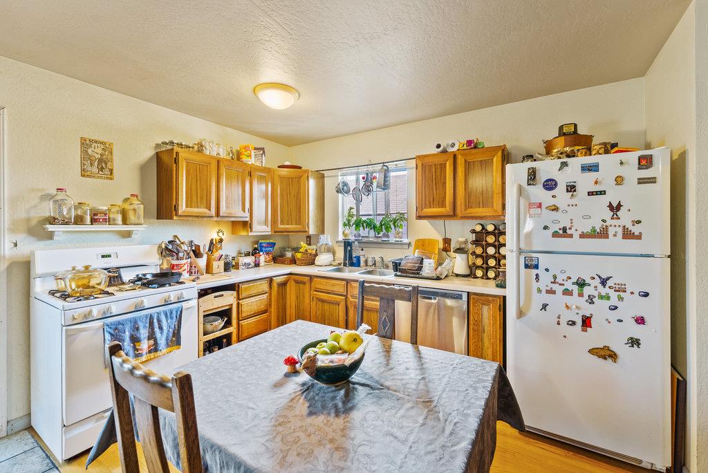 219-a Leonard Street Santa Cruz, CA 95060 - Photo 20 of 32 a kitchen with stainless steel appliances a stove a refrigerator a sink and wooden floor