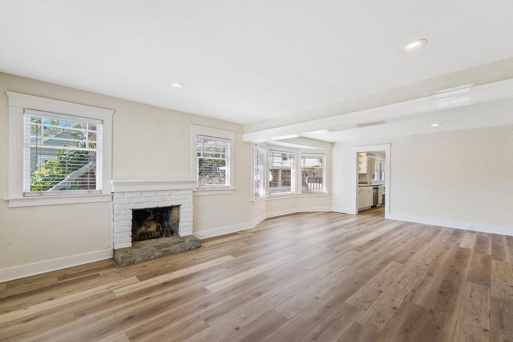 219-a Leonard Street Santa Cruz, CA 95060 - Photo 2 of 32 an empty room with wooden floor fireplace and windows