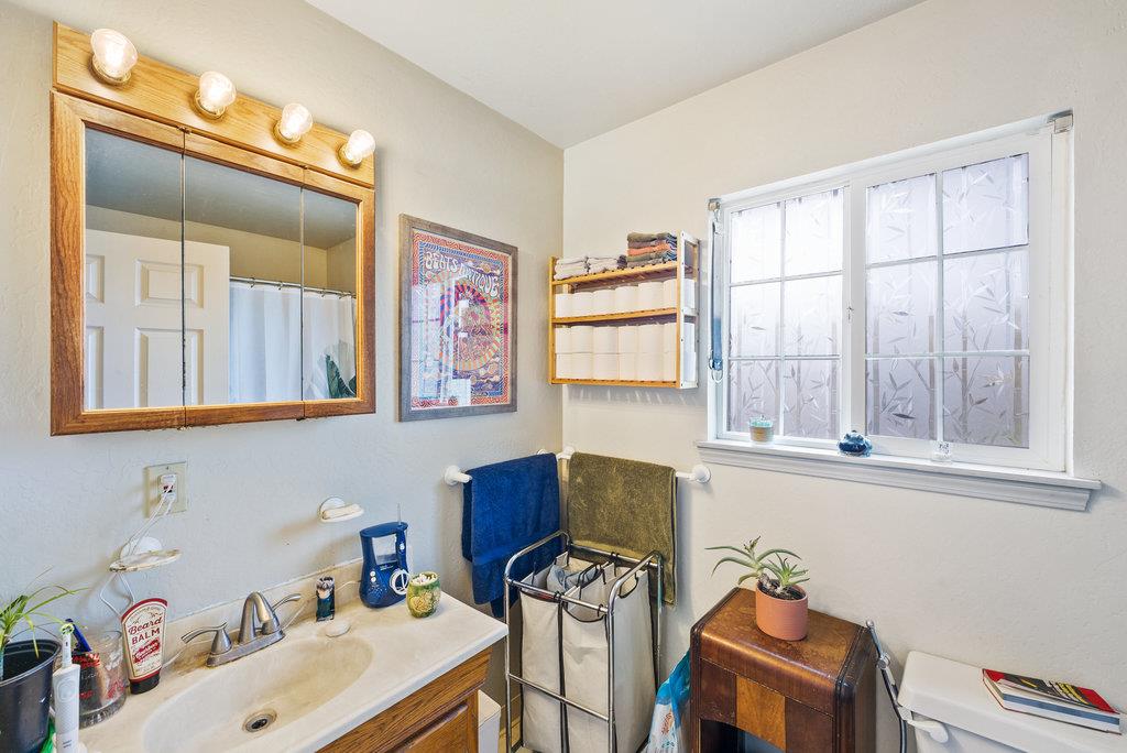 219-a Leonard Street Santa Cruz, CA 95060 - Photo 25 of 32 a bathroom with a window sink and a mirror
