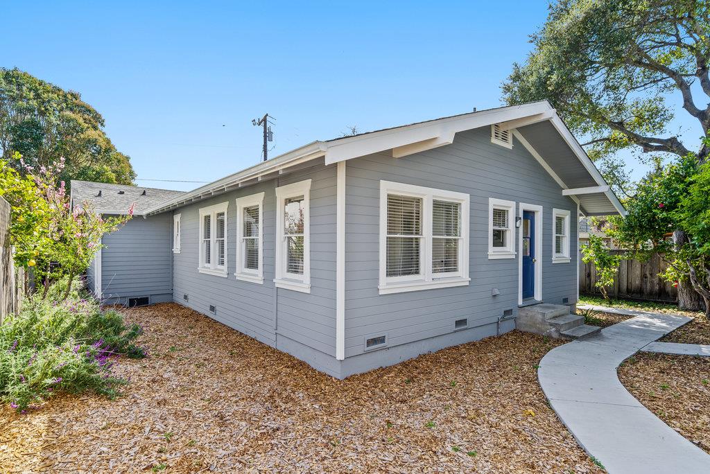 219-a Leonard Street Santa Cruz, CA 95060 - Photo 28 of 32 a backyard of a house with potted plants and large tree