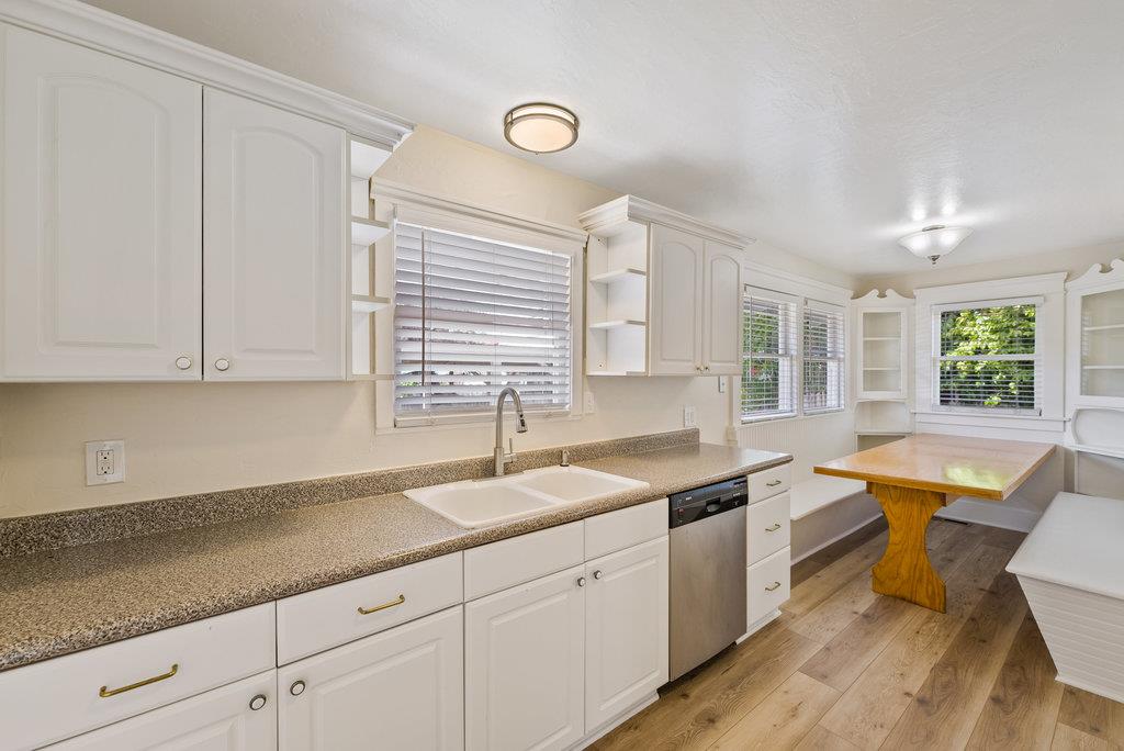 219-a Leonard Street Santa Cruz, CA 95060 - Photo 3 of 32 a kitchen with granite countertop a sink a window cabinets and stainless steel appliances