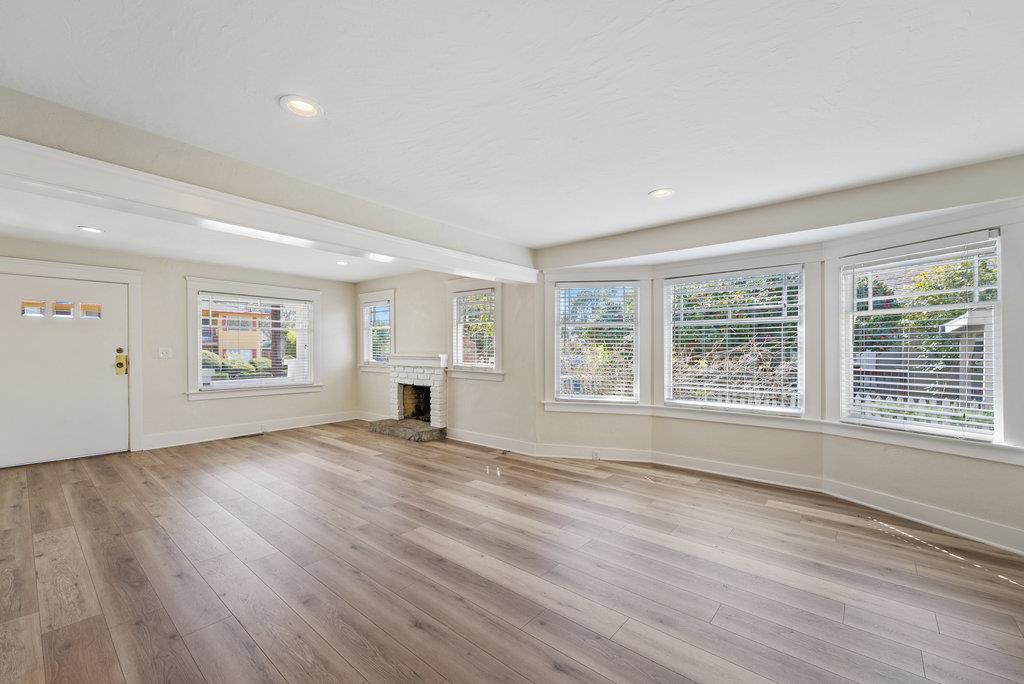 219-a Leonard Street Santa Cruz, CA 95060 - Photo 8 of 32 a view of an empty room with wooden floor and a window