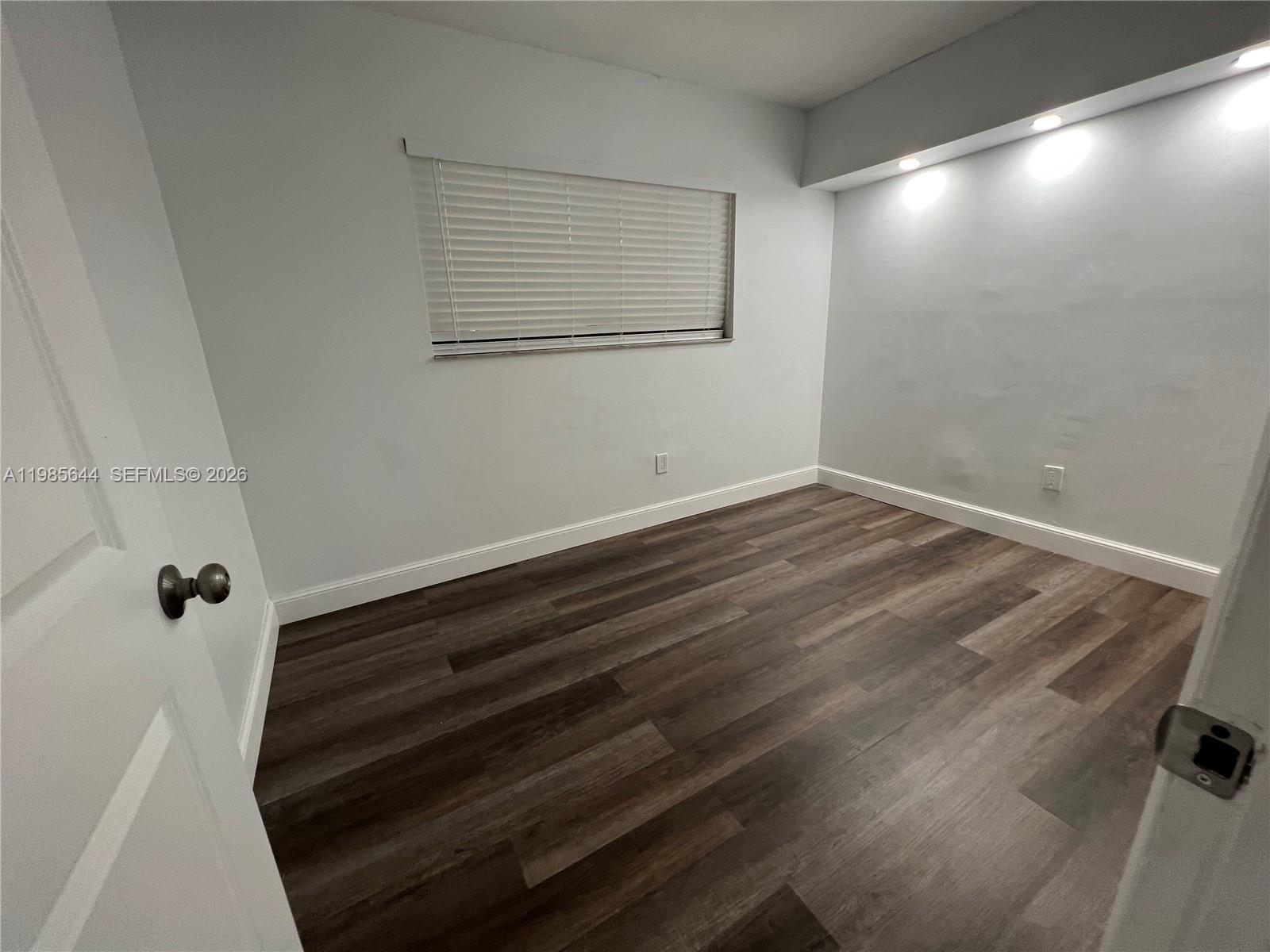 8635 Northwest 8th Street, Unit 211 Miami, FL 33126 - Photo 11 of 17 a view of small space with wooden floor