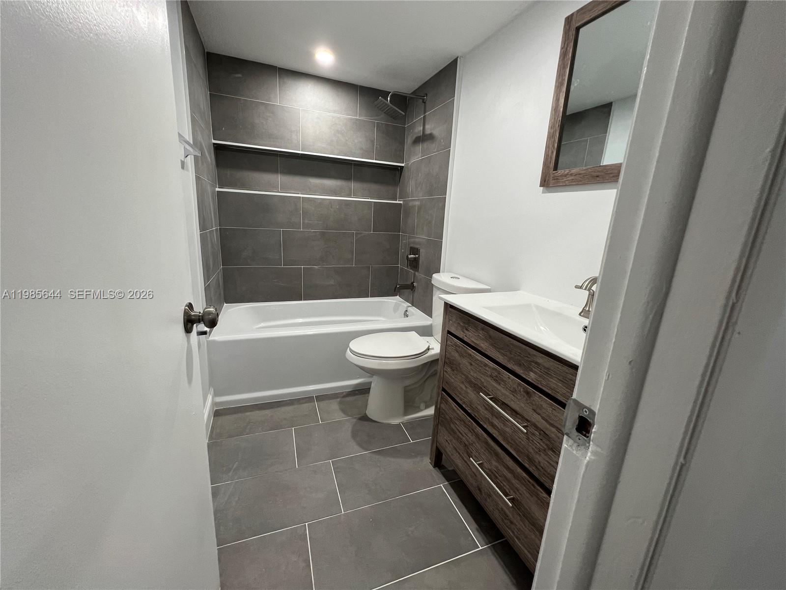 8635 Northwest 8th Street, Unit 211 Miami, FL 33126 - Photo 13 of 17 a bathroom with a toilet and a shower
