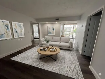 a living room with furniture and a rug