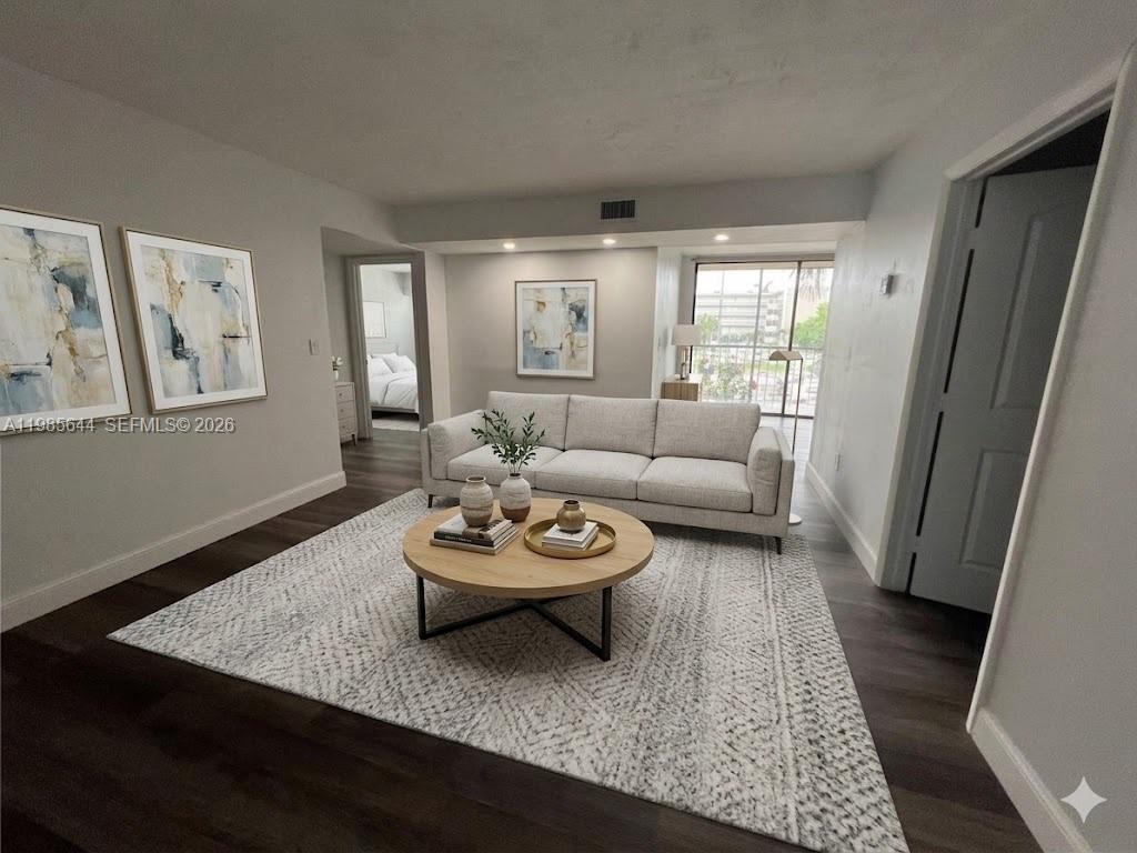 8635 Northwest 8th Street, Unit 211 Miami, FL 33126 - Photo 6 of 17 a living room with furniture and a rug