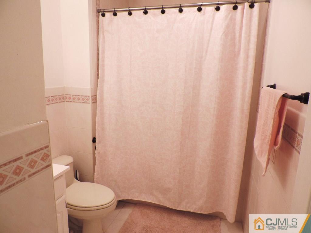 27 Columbia Road Old Bridge, NJ 08859 - Photo 12 of 24 a white toilet sitting next to a shower