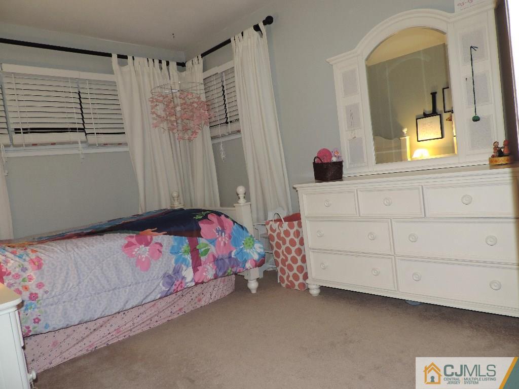 27 Columbia Road Old Bridge, NJ 08859 - Photo 15 of 24 a bedroom with a bed dresser and a window