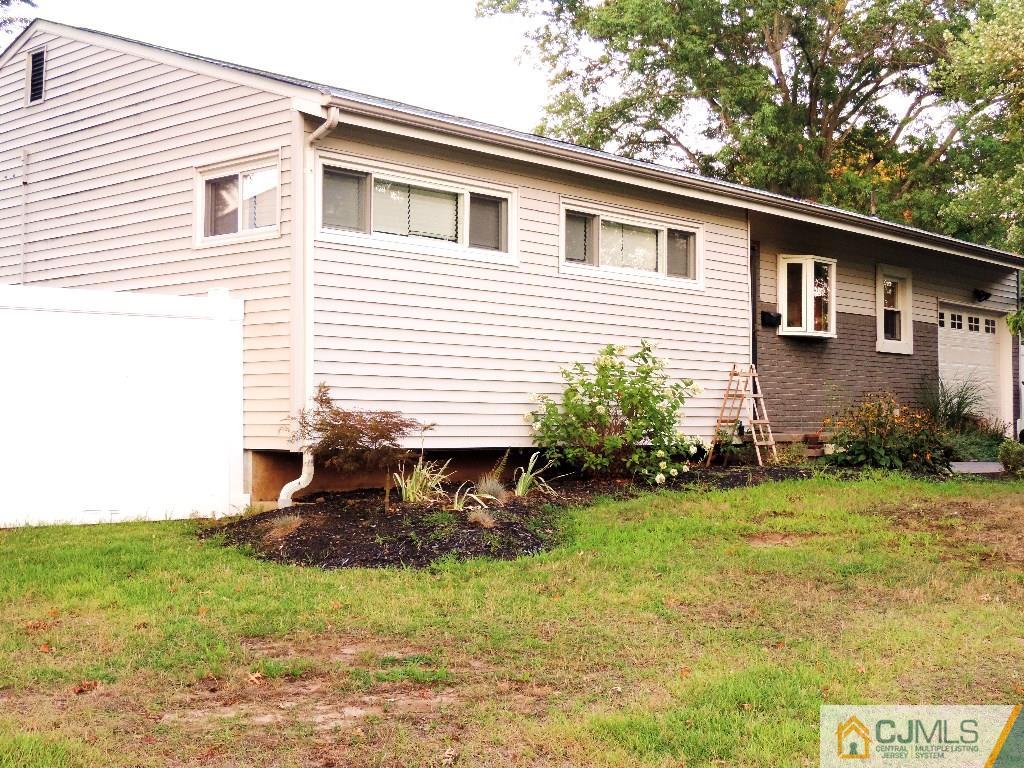 27 Columbia Road Old Bridge, NJ 08859 - Photo 23 of 24 a front view of a house with garden