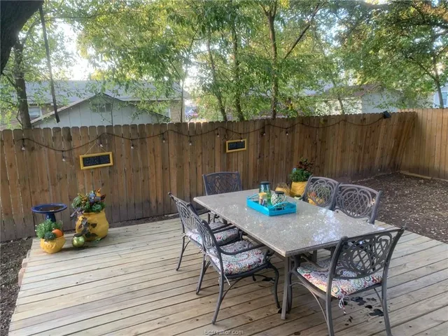 a view of a dinning table and chairs on the deck