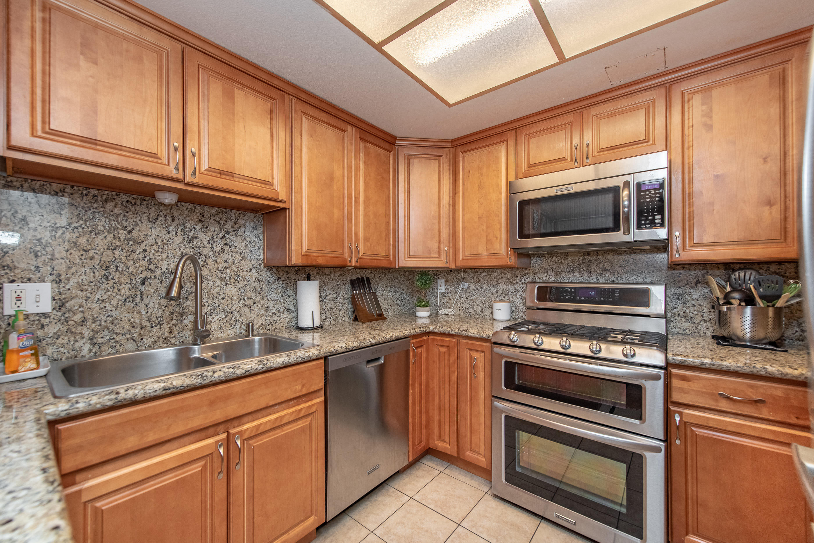 552 Spring Road, Unit 87 Moorpark, CA 93021 - Photo 11 of 29 a kitchen with stainless steel appliances granite countertop a sink stove and microwave