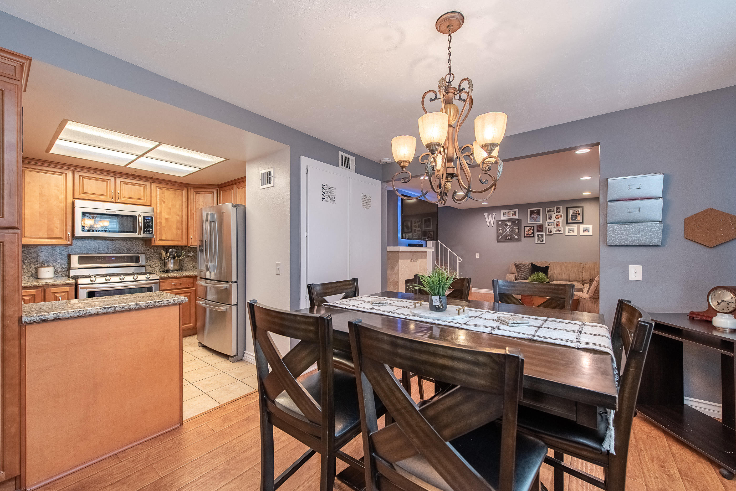 552 Spring Road, Unit 87 Moorpark, CA 93021 - Photo 14 of 29 a dining room filled chandelier and wooden floor