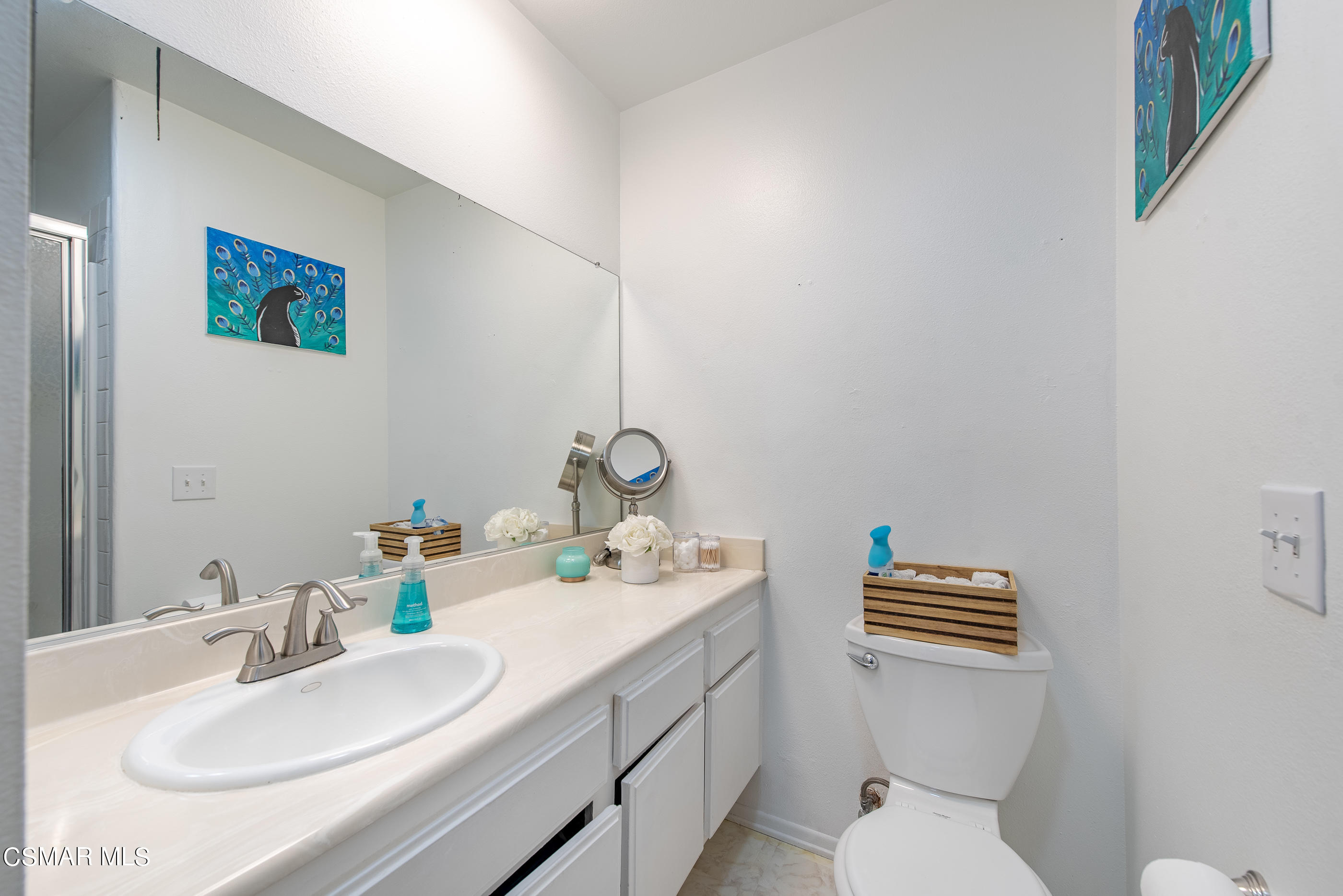 552 Spring Road, Unit 87 Moorpark, CA 93021 - Photo 22 of 29 a bathroom with a toilet sink and mirror