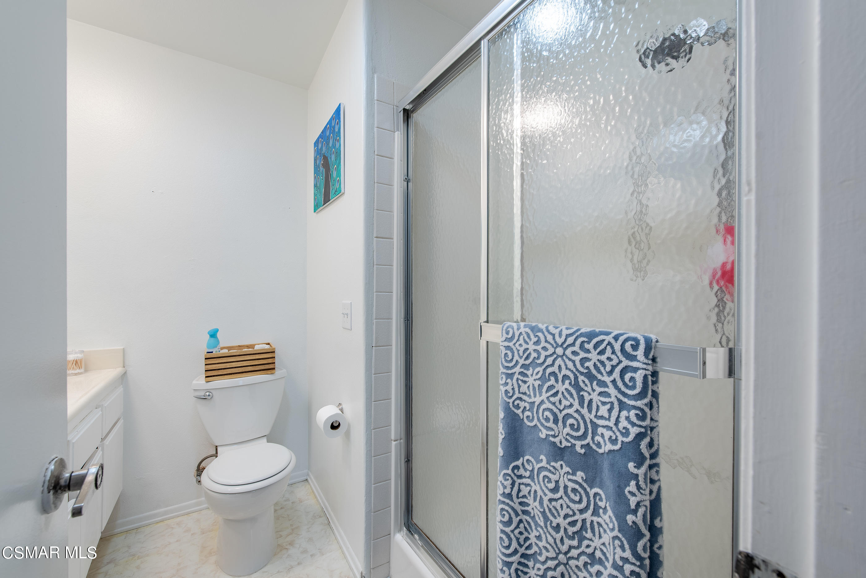 552 Spring Road, Unit 87 Moorpark, CA 93021 - Photo 23 of 29 a white toilet sitting next to a shower curtain