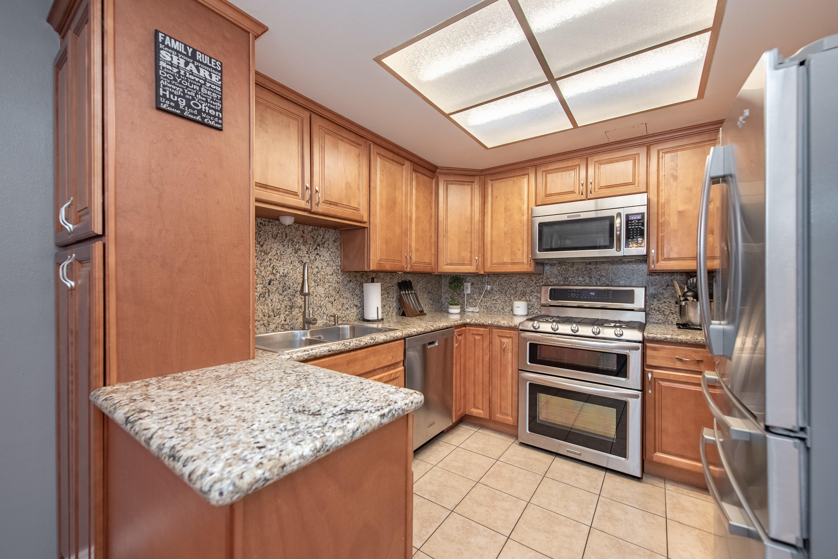 552 Spring Road, Unit 87 Moorpark, CA 93021 - Photo 9 of 29 a kitchen with stainless steel appliances granite countertop a sink stove and refrigerator