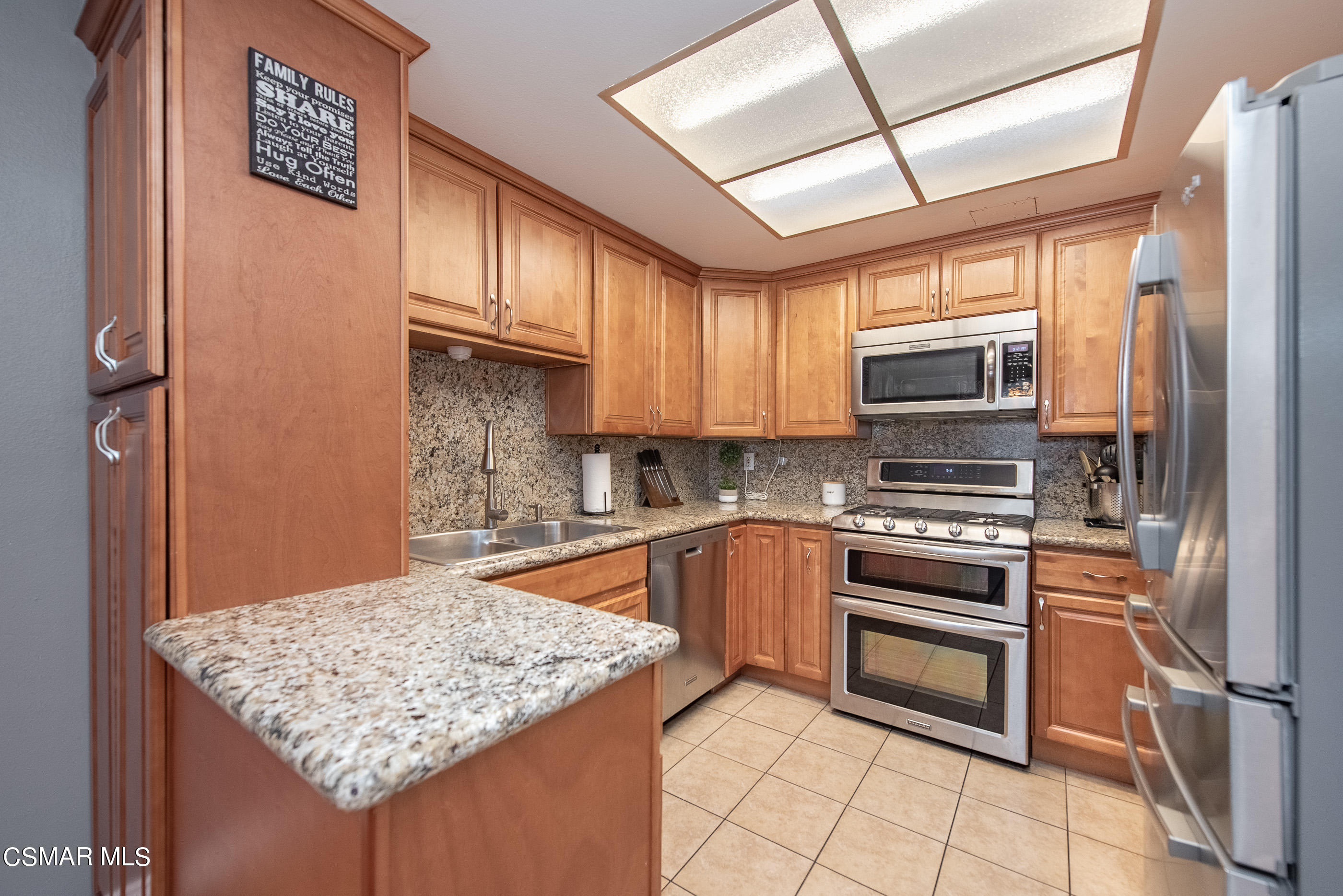 552 Spring Road, Unit 87 Moorpark, CA 93021 - Photo 10 of 29 a kitchen with stainless steel appliances granite countertop a sink stove and refrigerator