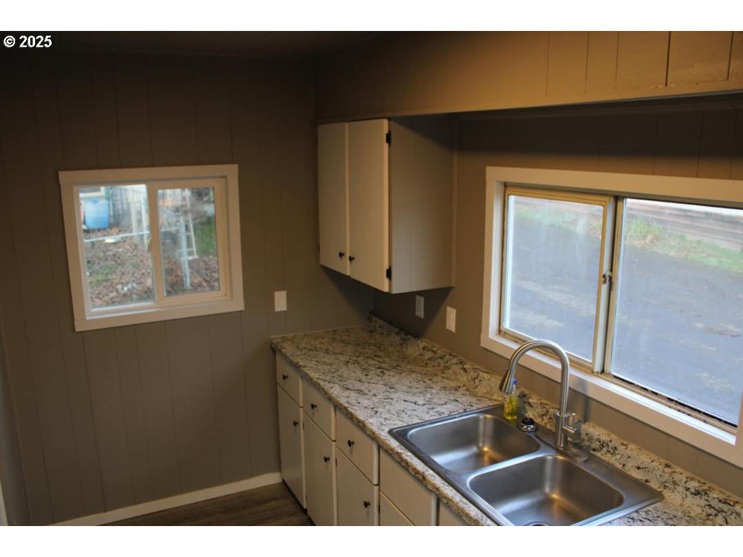 334 East 5th Avenue, Unit 3A Riddle, OR 97469 - Photo 4 of 8 a kitchen with a sink and cabinets