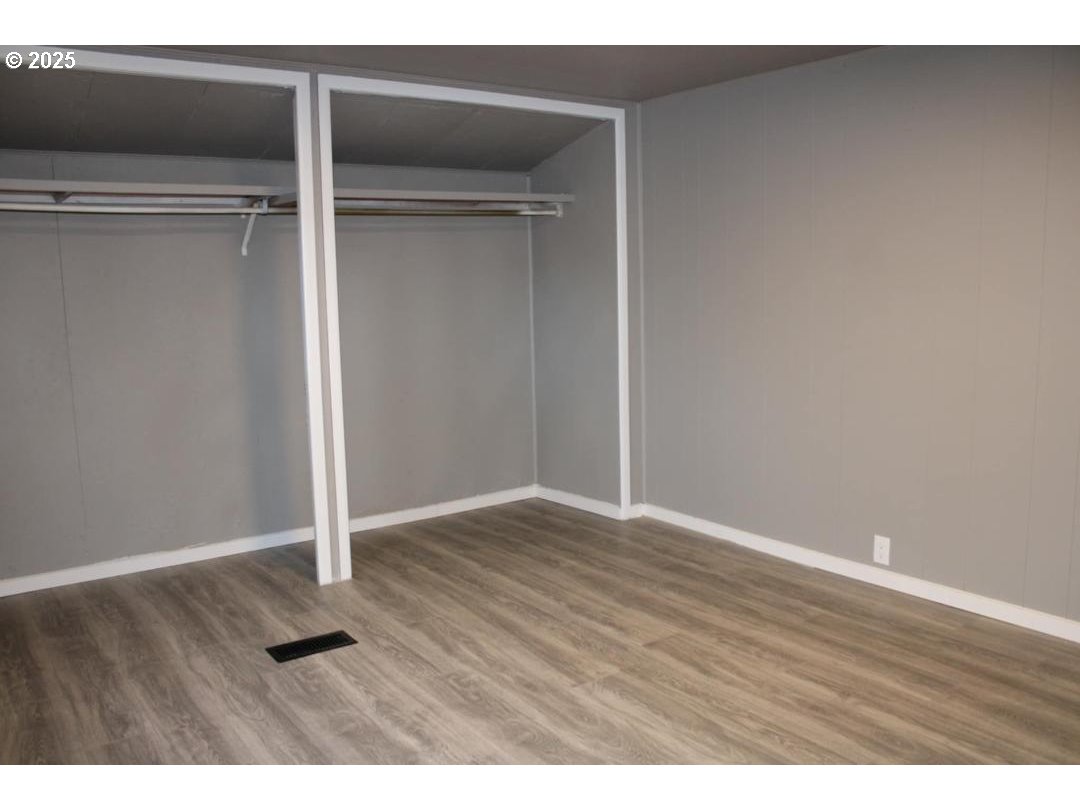 334 East 5th Avenue, Unit 3A Riddle, OR 97469 - Photo 7 of 8 a view of an empty room with wooden floor
