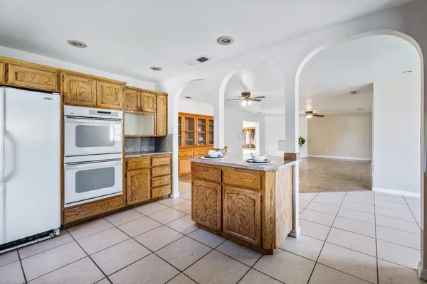 an empty room with a ceiling fan and entryway