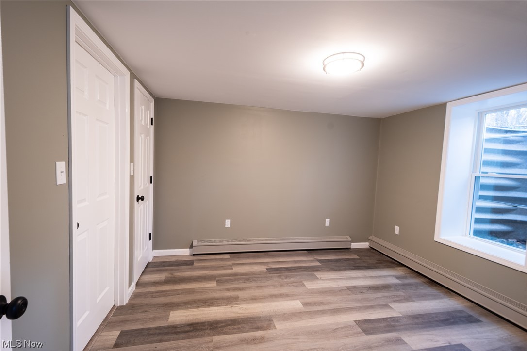 9980 Chardon Road Chardon, OH 44024 - Photo 33 of 46 Additional Bedroom featuring light hardwood / wood-style flooring and a baseboard radiator